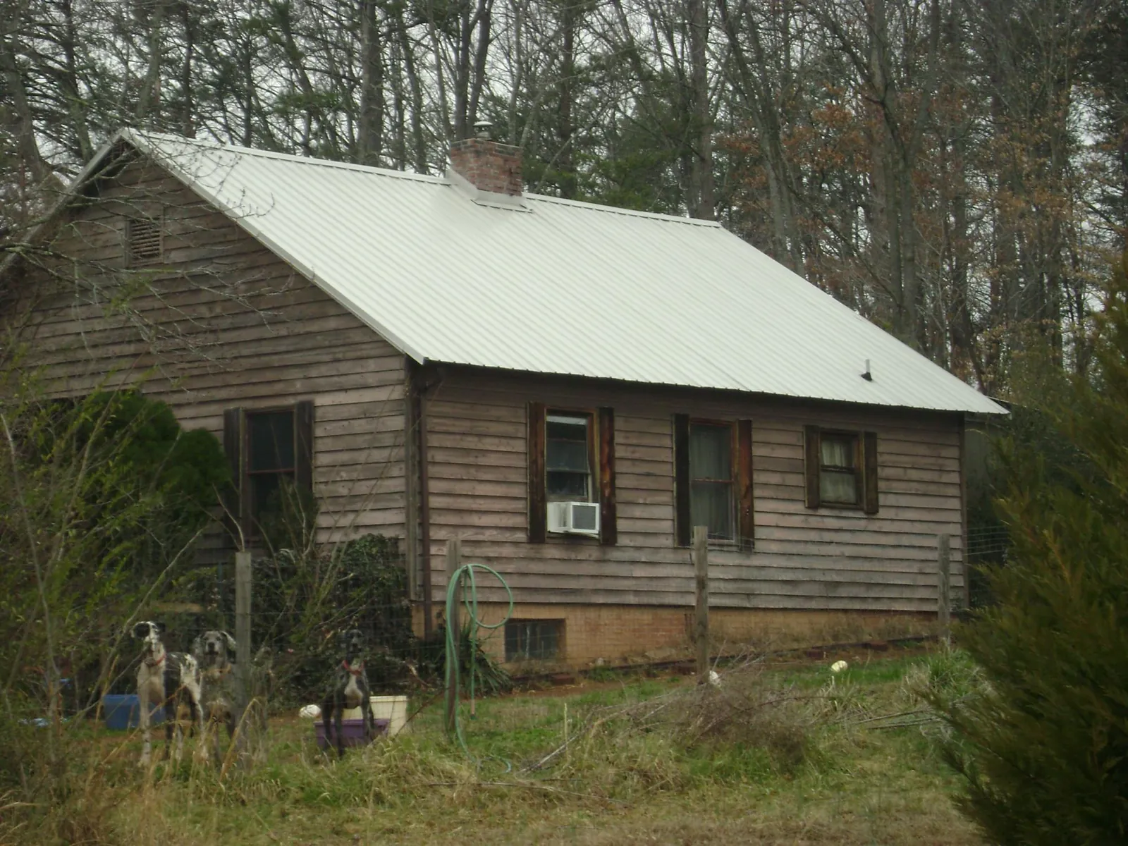White metal roof on an old wood sided farmhouse, from a Metal Roof Installation job in Pomfret